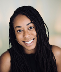 Woman with black hair and black sleeveless top smiling